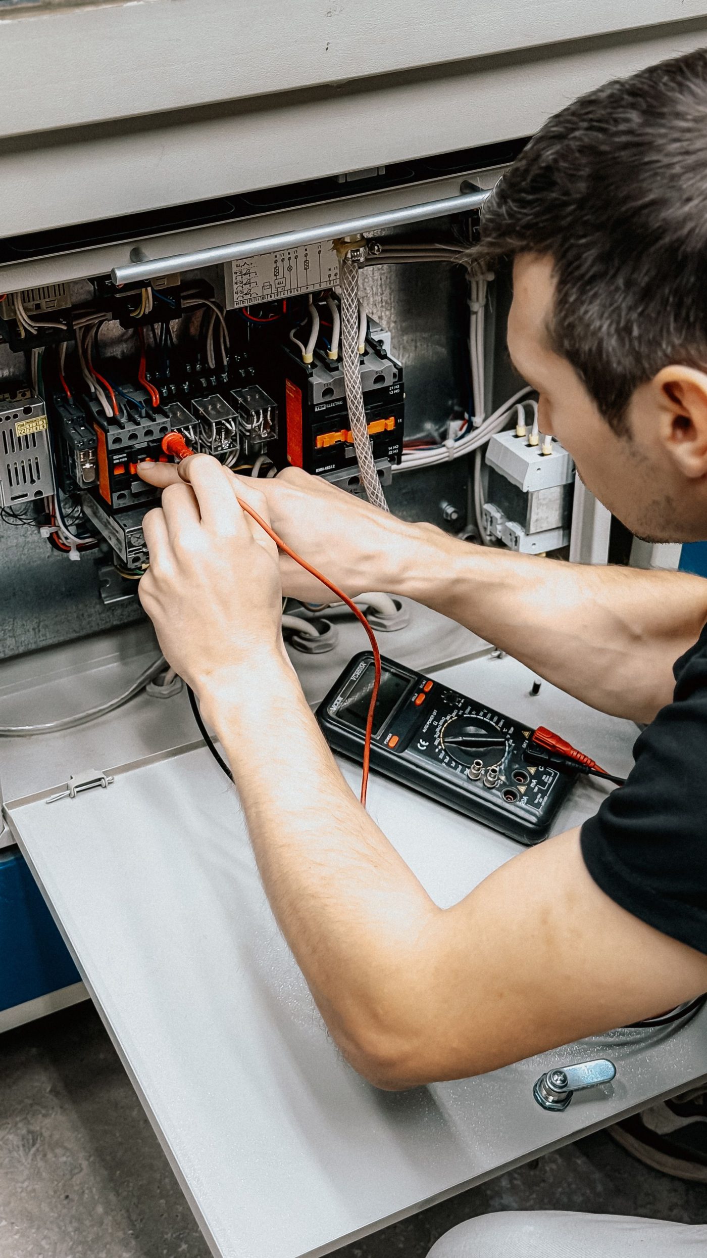 Electrician working on an electrical panel on site