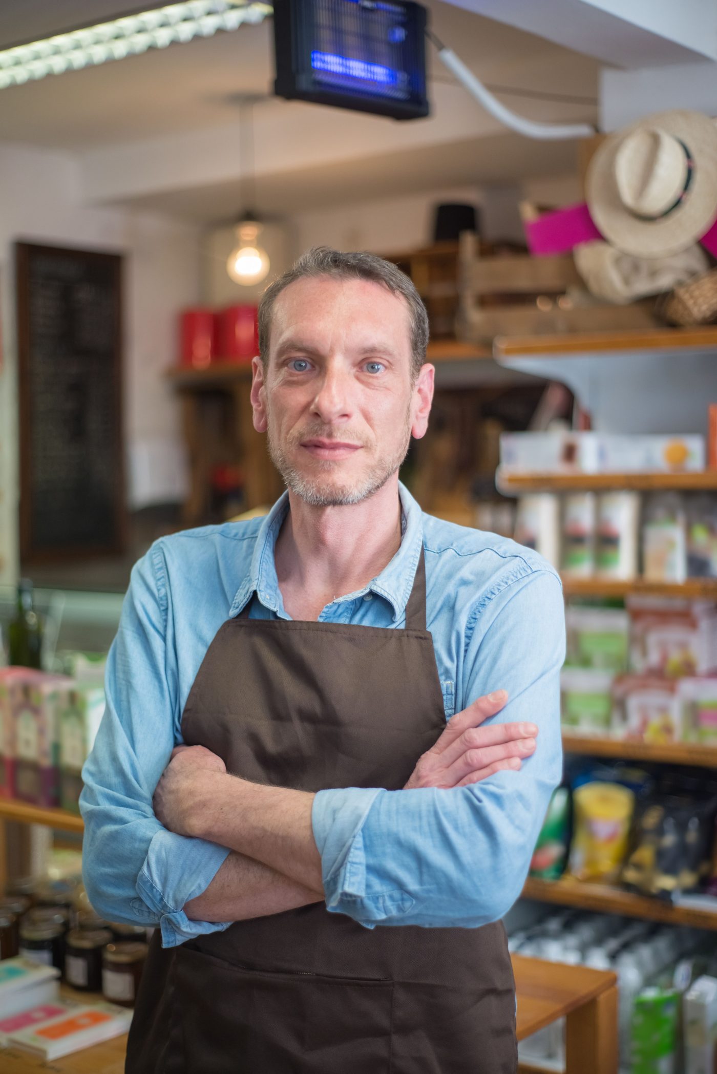 A small retail shop owner standing in his store